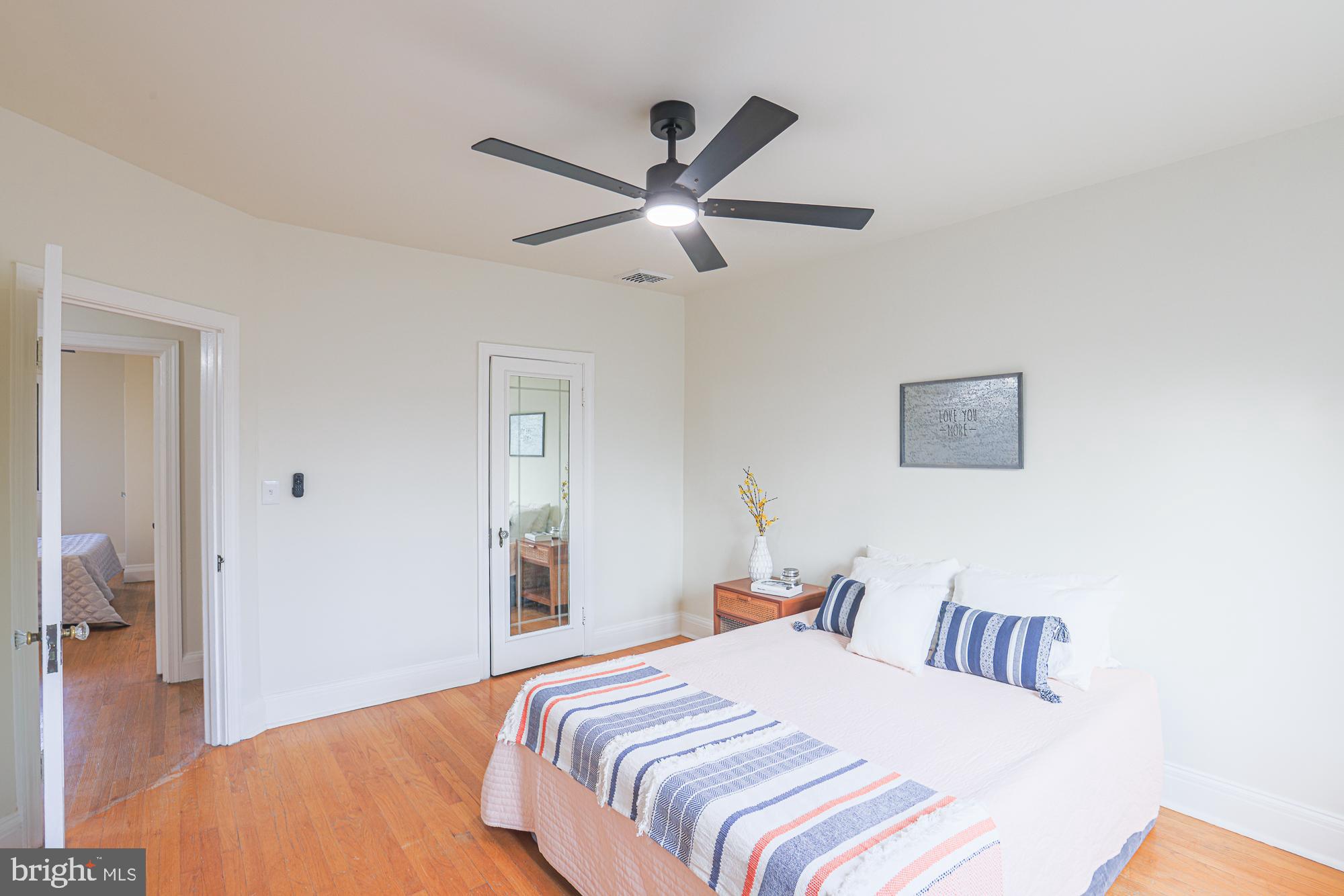 3716 Rexmere Road Baltimore, MD 21218 - Photo 31 of 54 a bedroom with a large bed and a chandelier