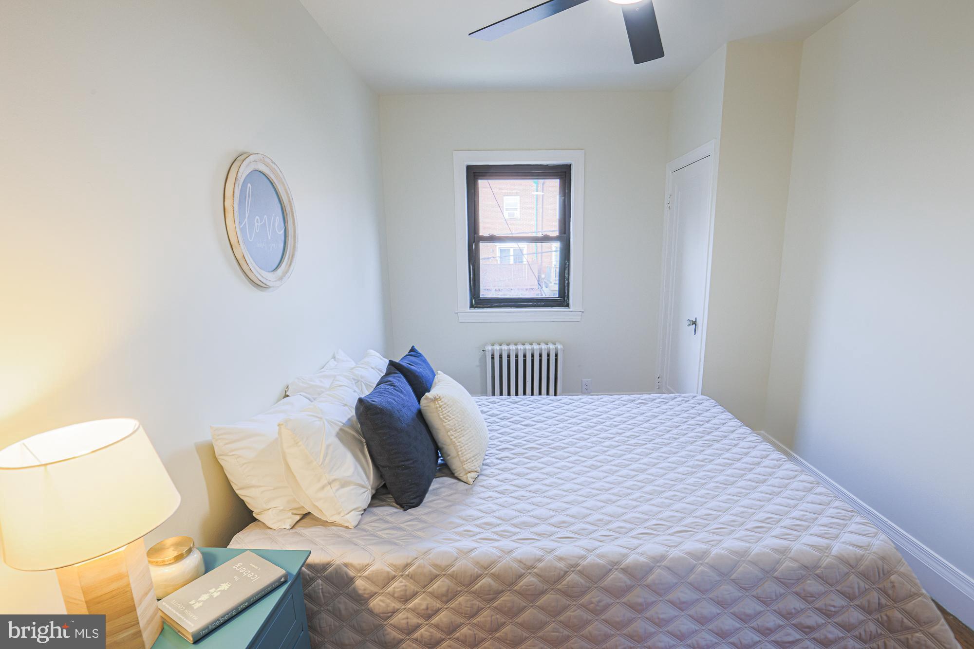 3716 Rexmere Road Baltimore, MD 21218 - Photo 33 of 54 a bedroom with a bed and a lamp