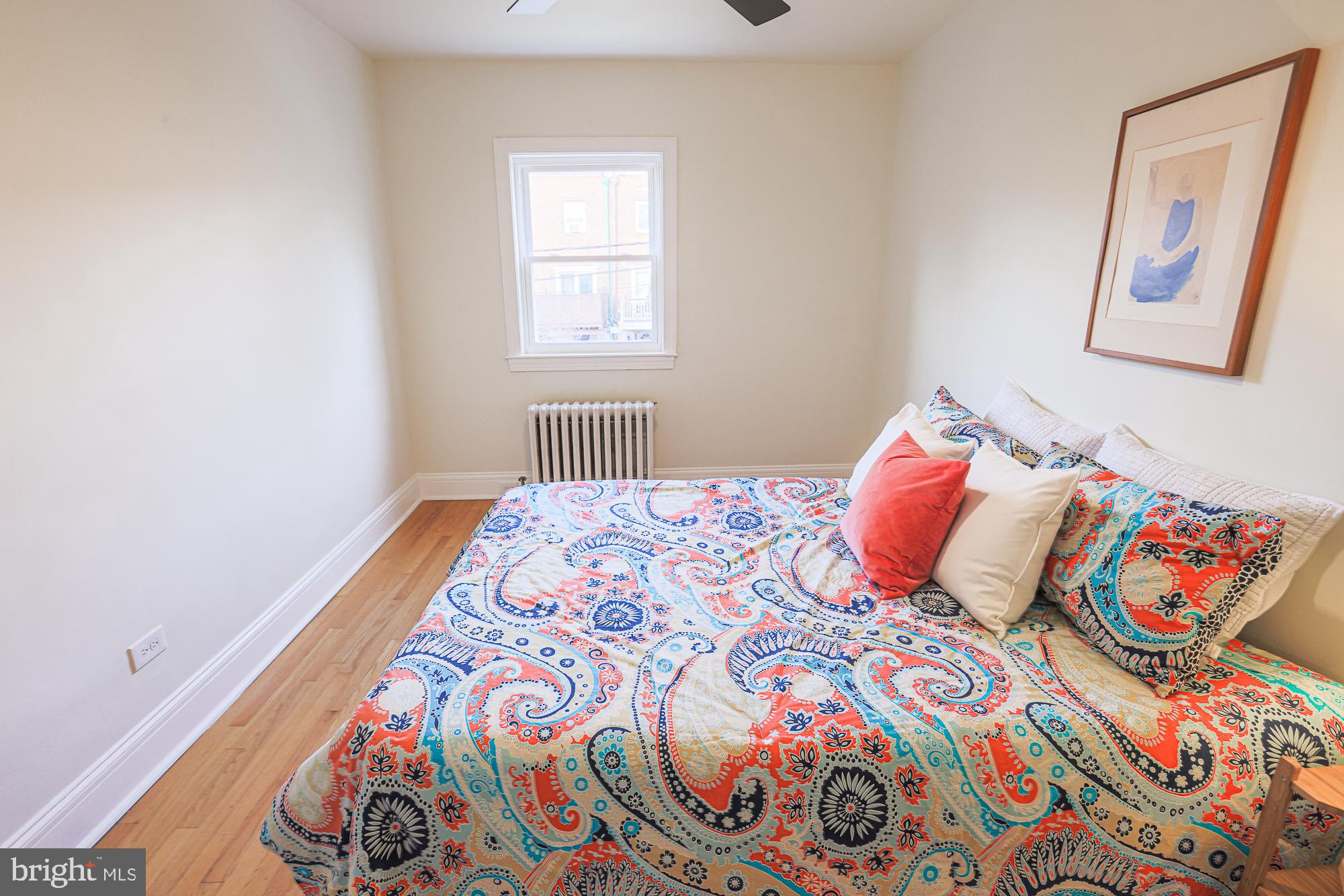 3716 Rexmere Road Baltimore, MD 21218 - Photo 35 of 54 a bedroom with a bed and a painting on the wall