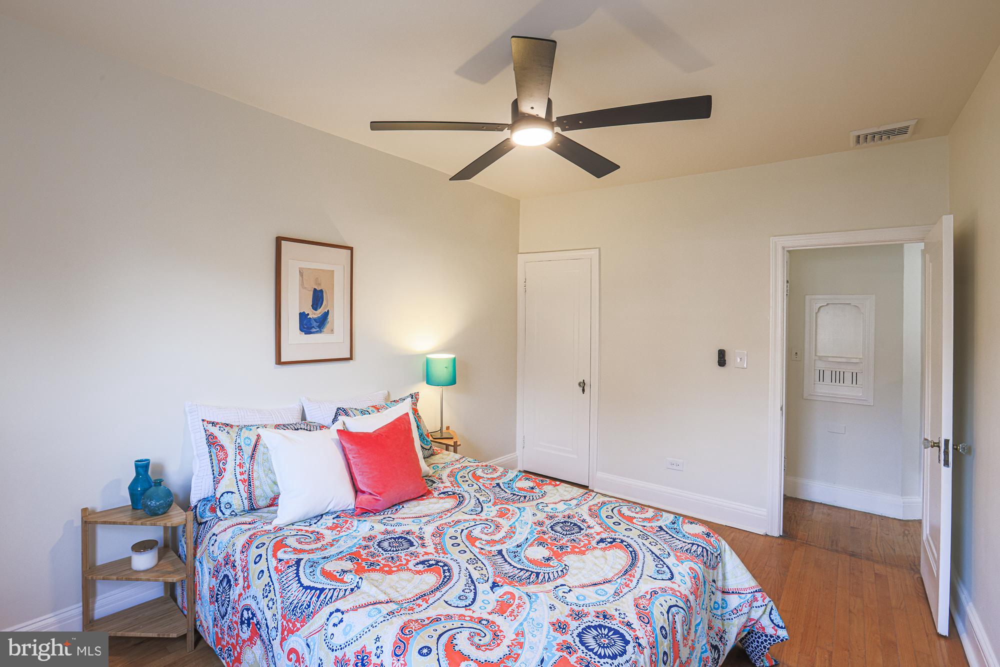 3716 Rexmere Road Baltimore, MD 21218 - Photo 36 of 54 a bedroom with a large bed and a chandelier