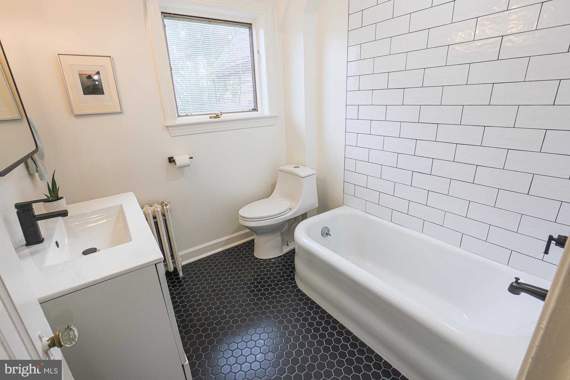 3716 Rexmere Road Baltimore, MD 21218 - Photo 39 of 54 a bath room with a toilet a bath tub and a sink