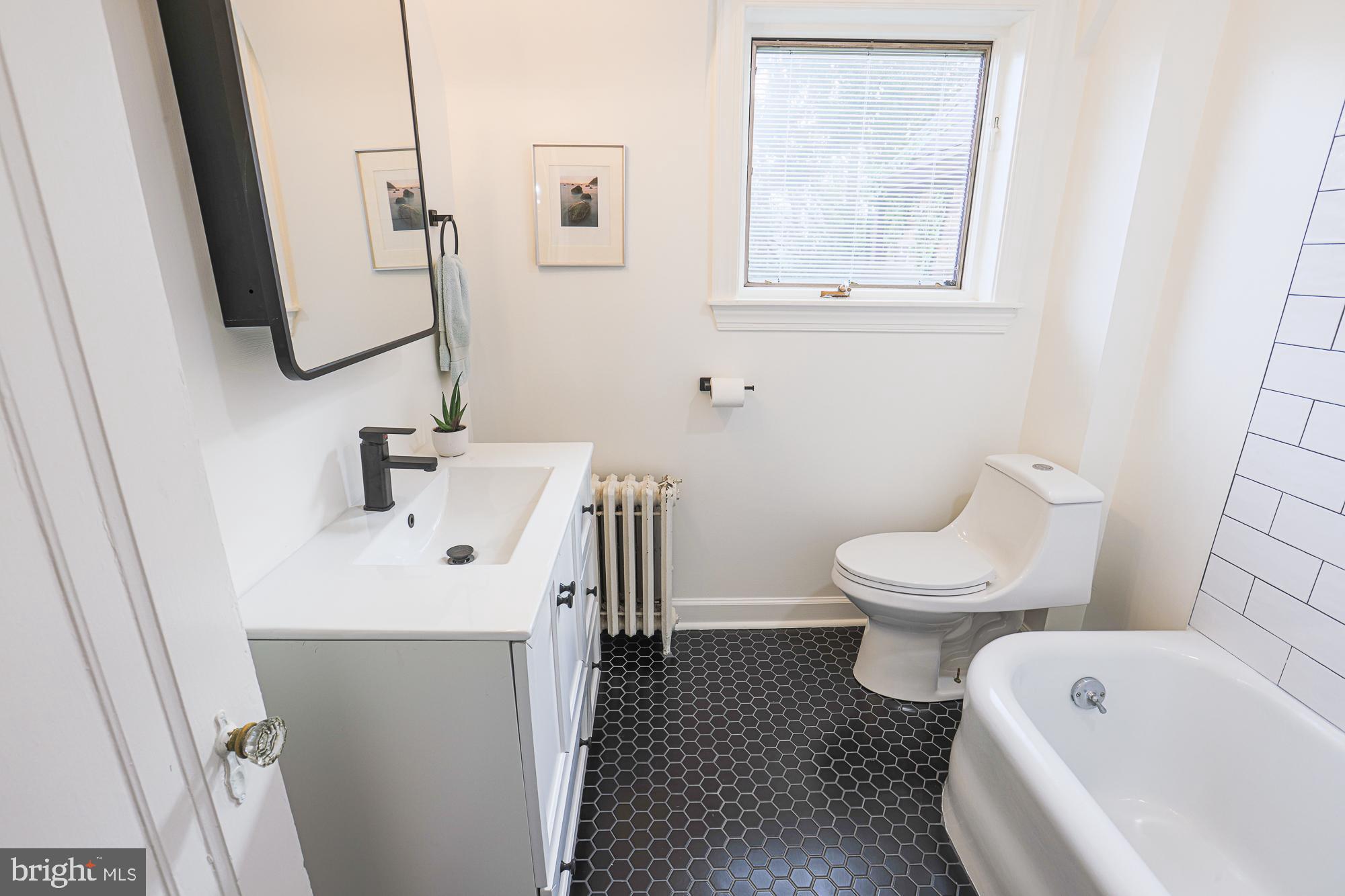 3716 Rexmere Road Baltimore, MD 21218 - Photo 40 of 54 a white toilet sitting next to a bathroom sink