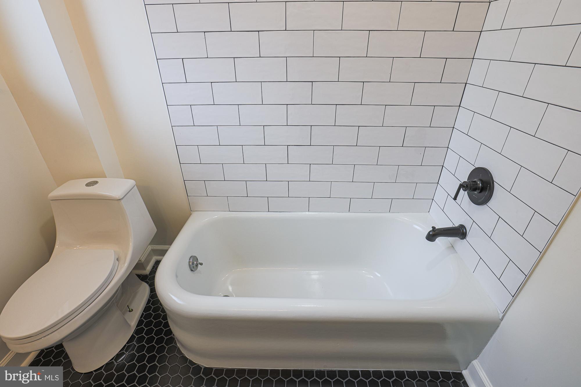3716 Rexmere Road Baltimore, MD 21218 - Photo 41 of 54 a white bath tub sitting next to a white toilet
