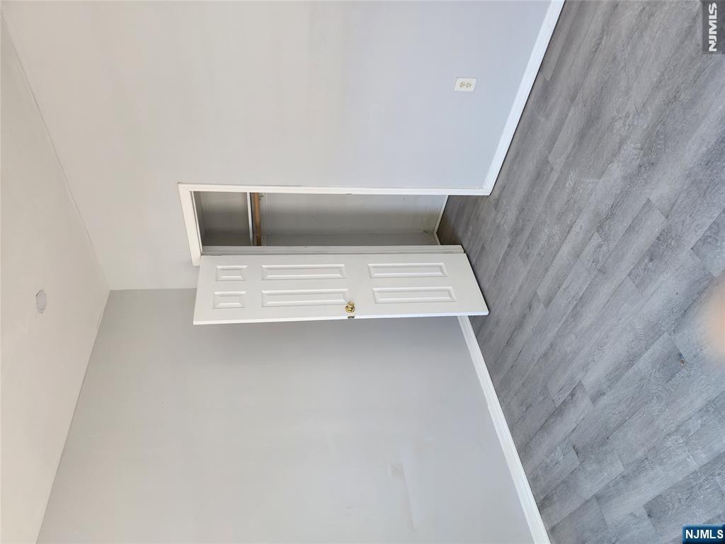 347 Avon Avenue Newark, NJ 07108 - Photo 3 of 4 a view of an empty room with wooden floor and closet