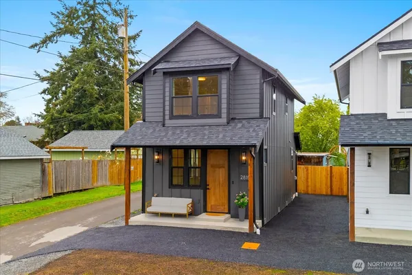 a front view of a house with a garden