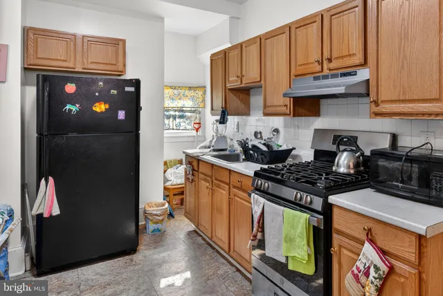 a kitchen with stainless steel appliances granite countertop a stove a refrigerator and a microwave