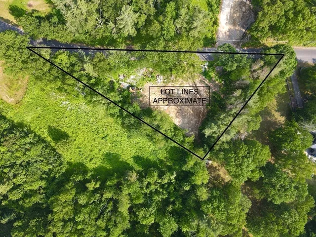 a view of a field with a building in the background