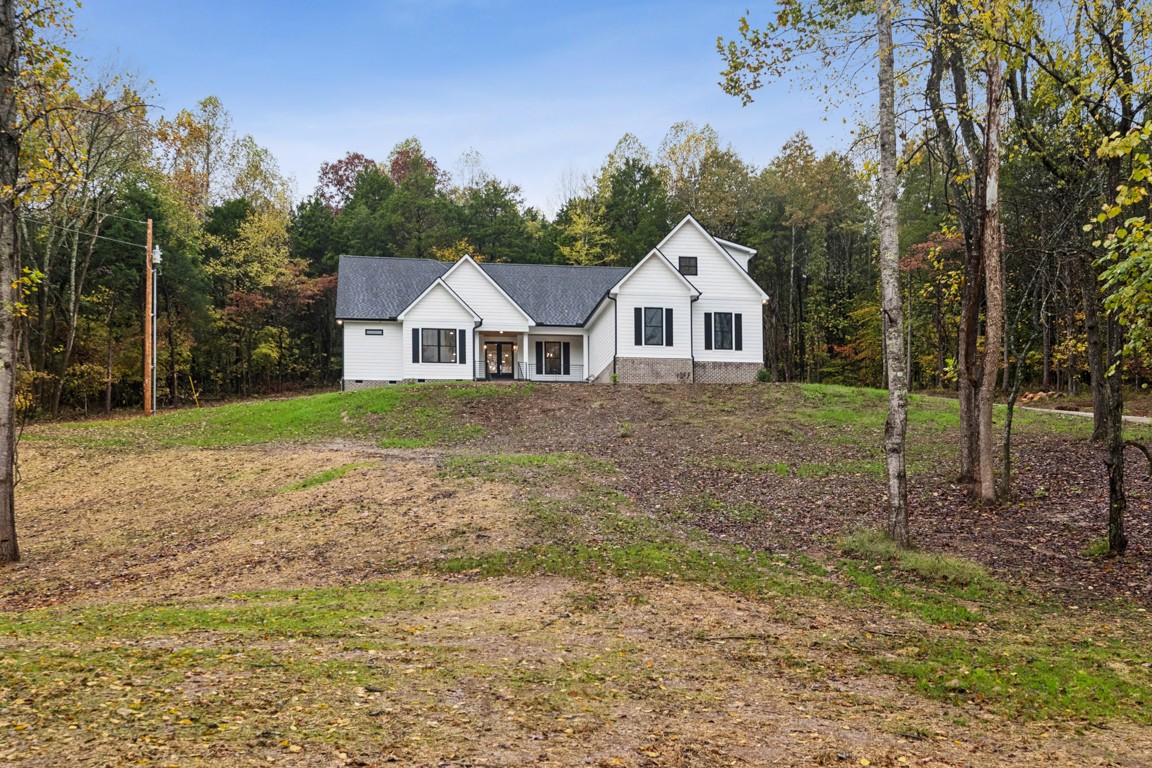 6461 Highway 48 North Cumberland Furnace, TN 37051 - Photo 1 of 25 a view of a yard in front of a house with large trees