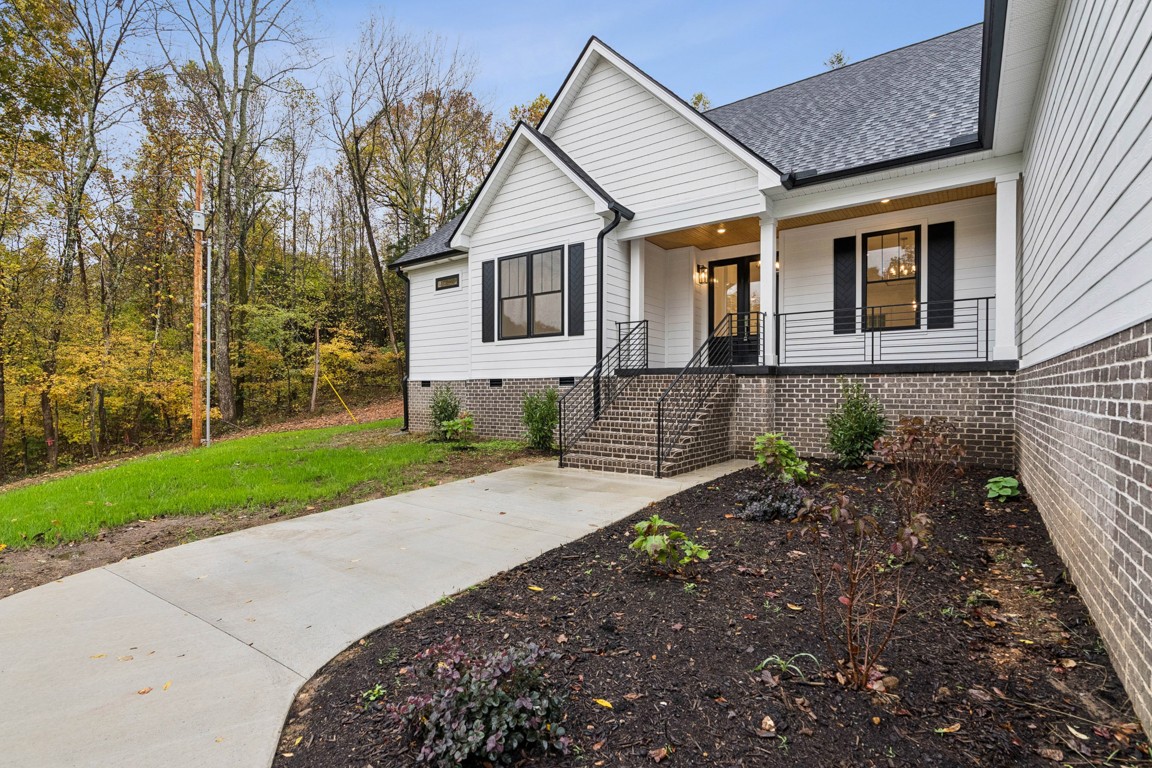 6461 Highway 48 North Cumberland Furnace, TN 37051 - Photo 3 of 25 a front view of a house with a yard and pathway