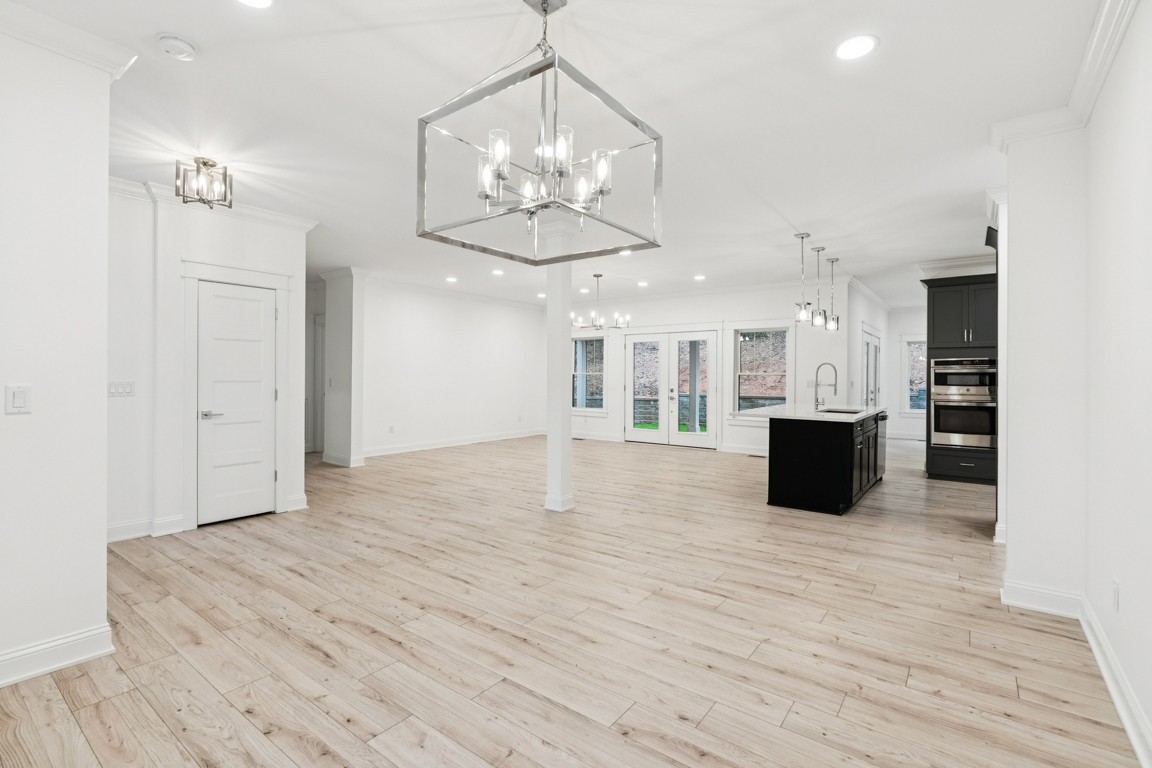 6461 Highway 48 North Cumberland Furnace, TN 37051 - Photo 6 of 25 a view of an empty room and kitchen with wooden floor