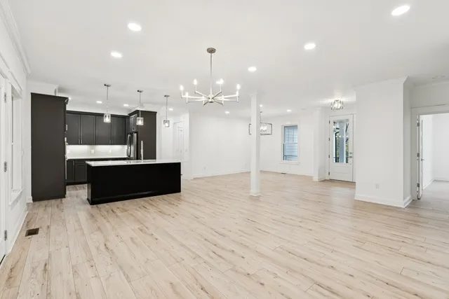 a large room with a sink and a refrigerator