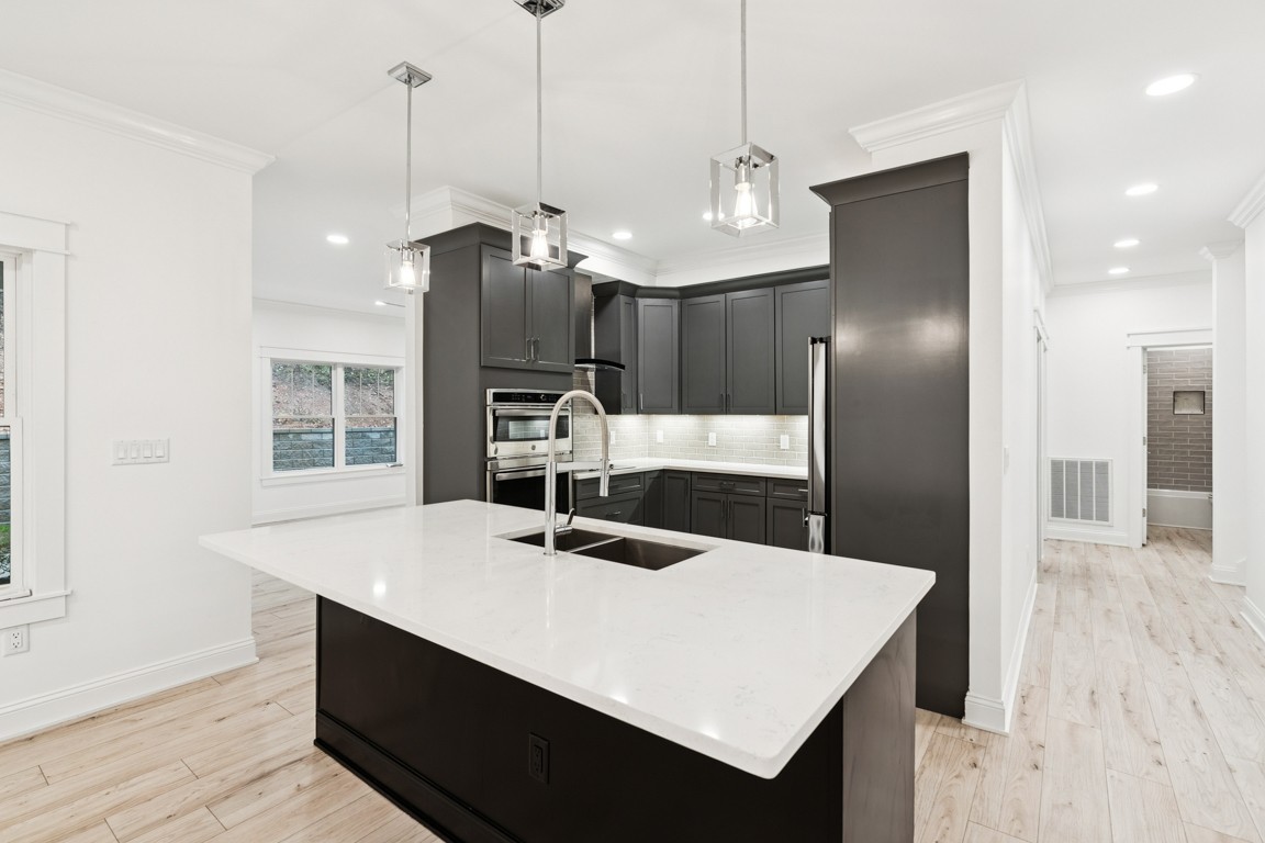 6461 Highway 48 North Cumberland Furnace, TN 37051 - Photo 8 of 25 a large kitchen with sink a refrigerator and chairs