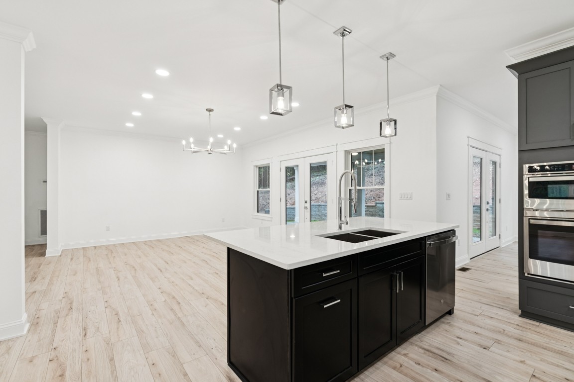 6461 Highway 48 North Cumberland Furnace, TN 37051 - Photo 9 of 25 a kitchen with a sink chandelier and wooden floor