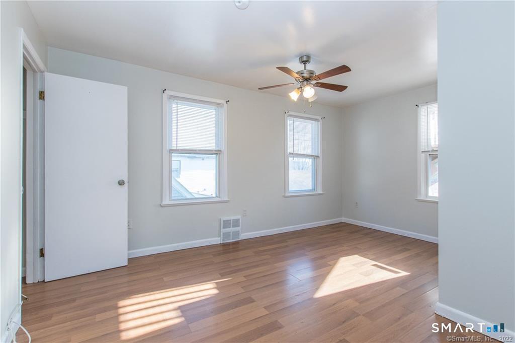 18 Lawrence Street Norwalk, CT 06854 - Photo 22 of 31 a view of empty room with wooden floor and fan