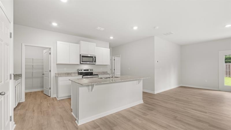 9 Babcock Drive Northeast Rome, GA 30165 - Photo 5 of 52 a kitchen with stainless steel appliances granite countertop a stove top oven a sink and a refrigerator