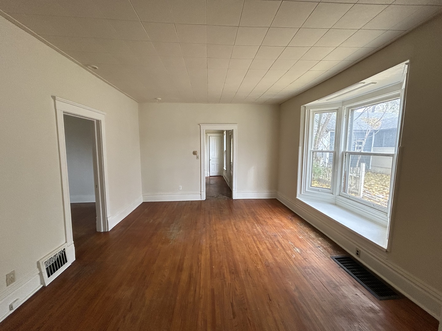 376 Jefferson Avenue Elgin, IL 60120 - Photo 12 of 21 an empty room with wooden floor and windows