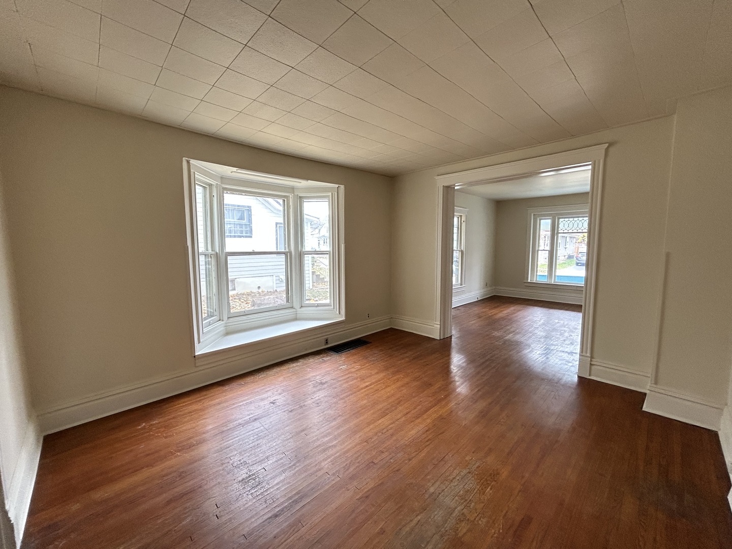 376 Jefferson Avenue Elgin, IL 60120 - Photo 13 of 21 wooden floor in an empty room with a window