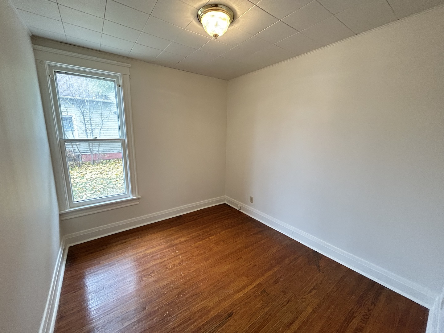 376 Jefferson Avenue Elgin, IL 60120 - Photo 15 of 21 an empty room with wooden floor and windows