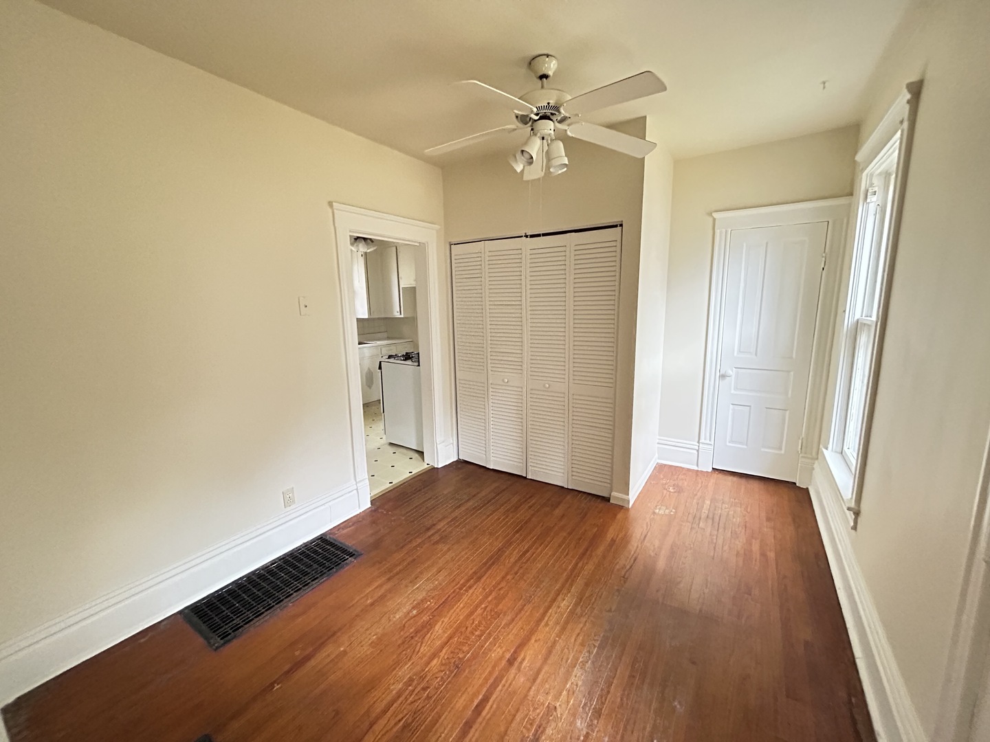 376 Jefferson Avenue Elgin, IL 60120 - Photo 19 of 21 wooden floor in an empty room with a window