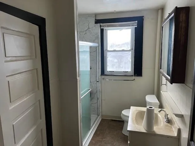 a bathroom with a sink toilet and mirror