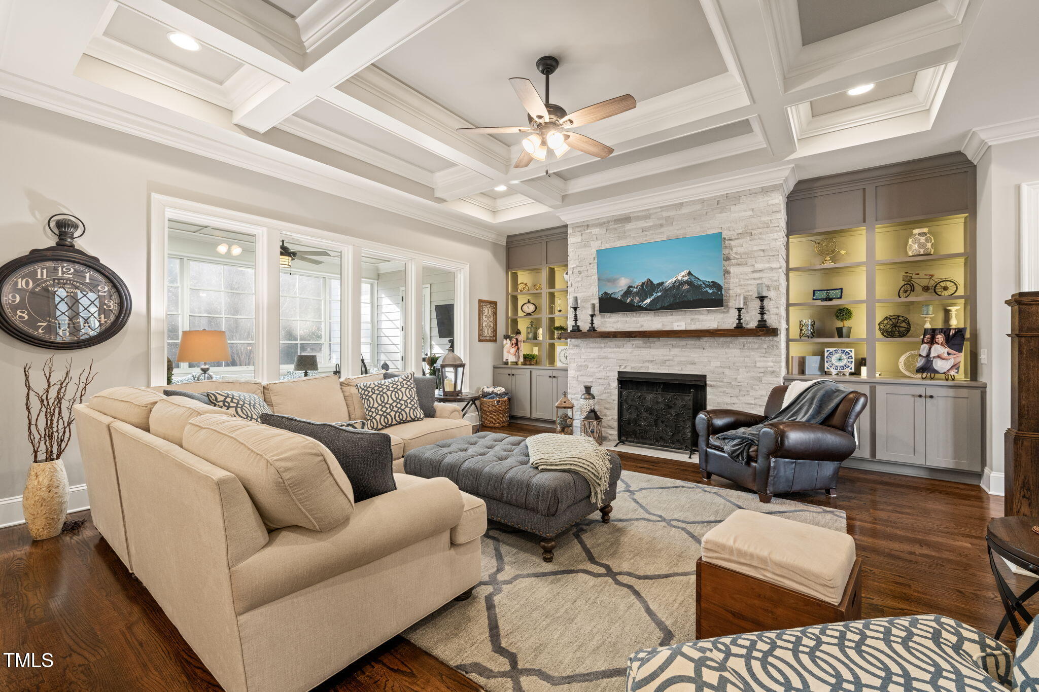 1301 Mackinaw Drive Wake Forest, NC 27587 - Photo 15 of 55 a living room with furniture a fireplace and a chandelier
