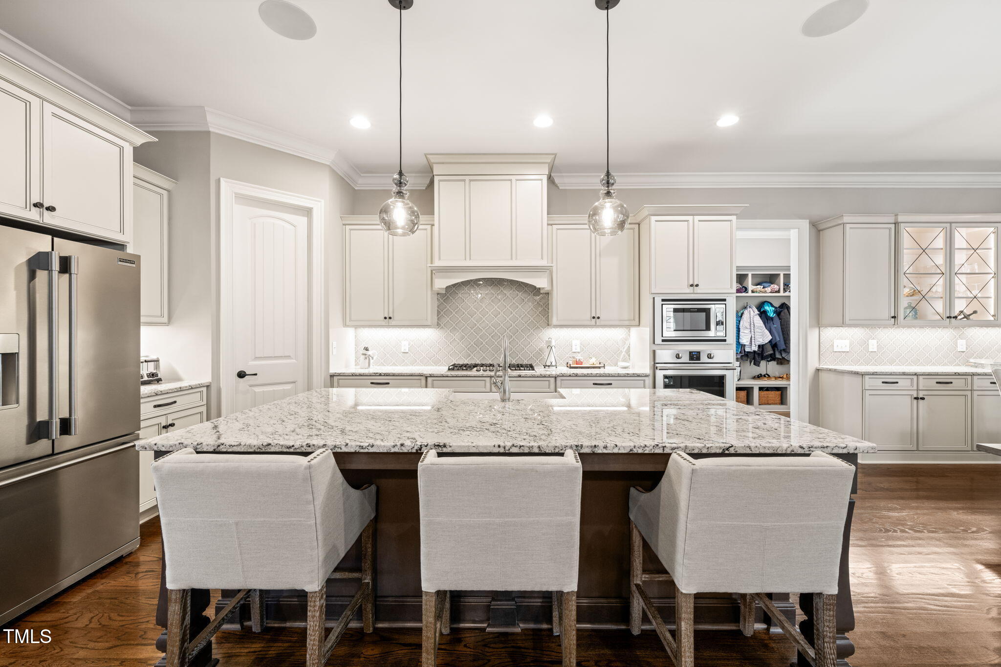 1301 Mackinaw Drive Wake Forest, NC 27587 - Photo 18 of 55 a kitchen with stainless steel appliances granite countertop a table chairs stove and refrigerator