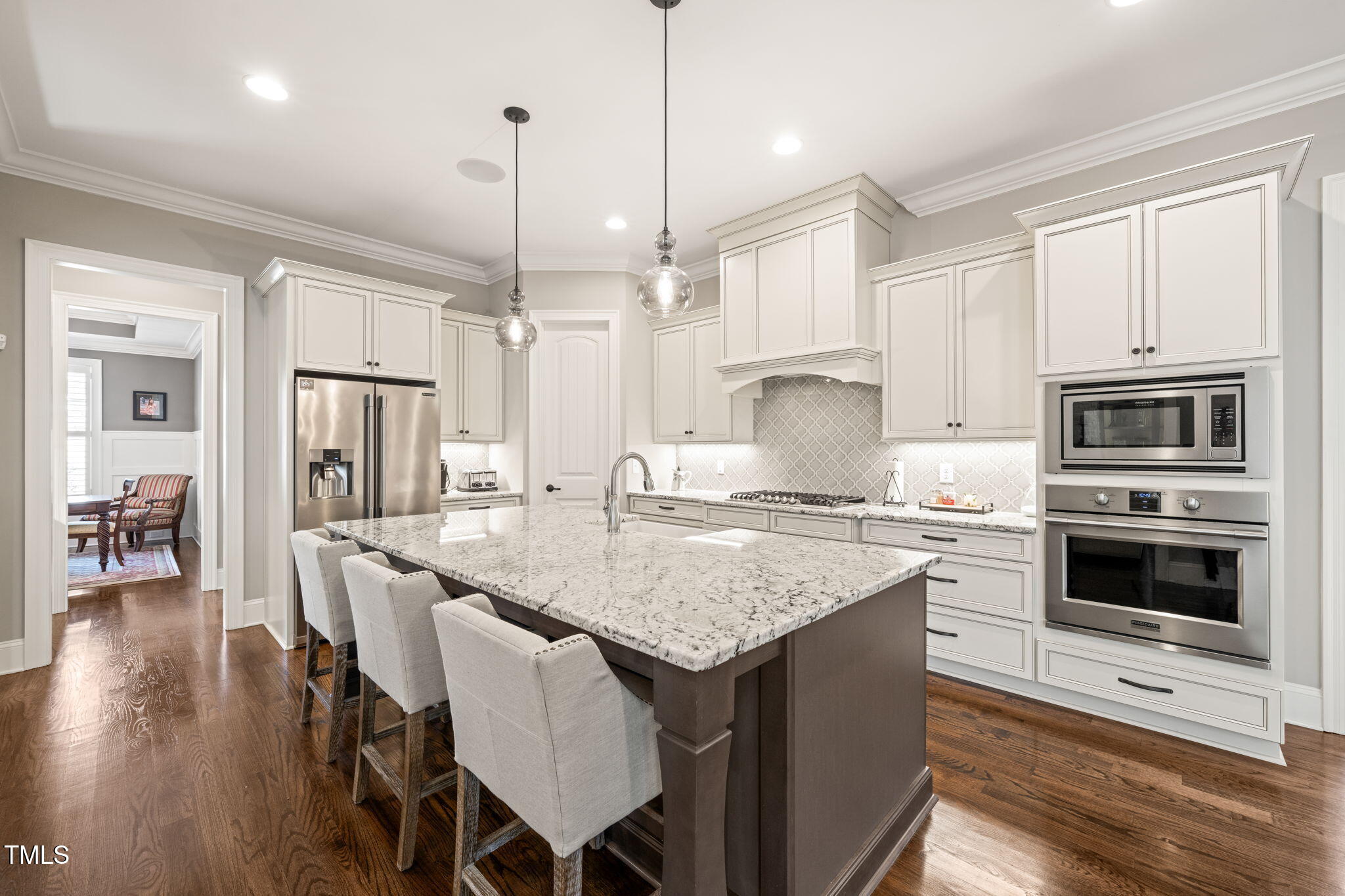 1301 Mackinaw Drive Wake Forest, NC 27587 - Photo 19 of 55 a kitchen with stainless steel appliances granite countertop a stove a sink refrigerator and a wooden cabinets