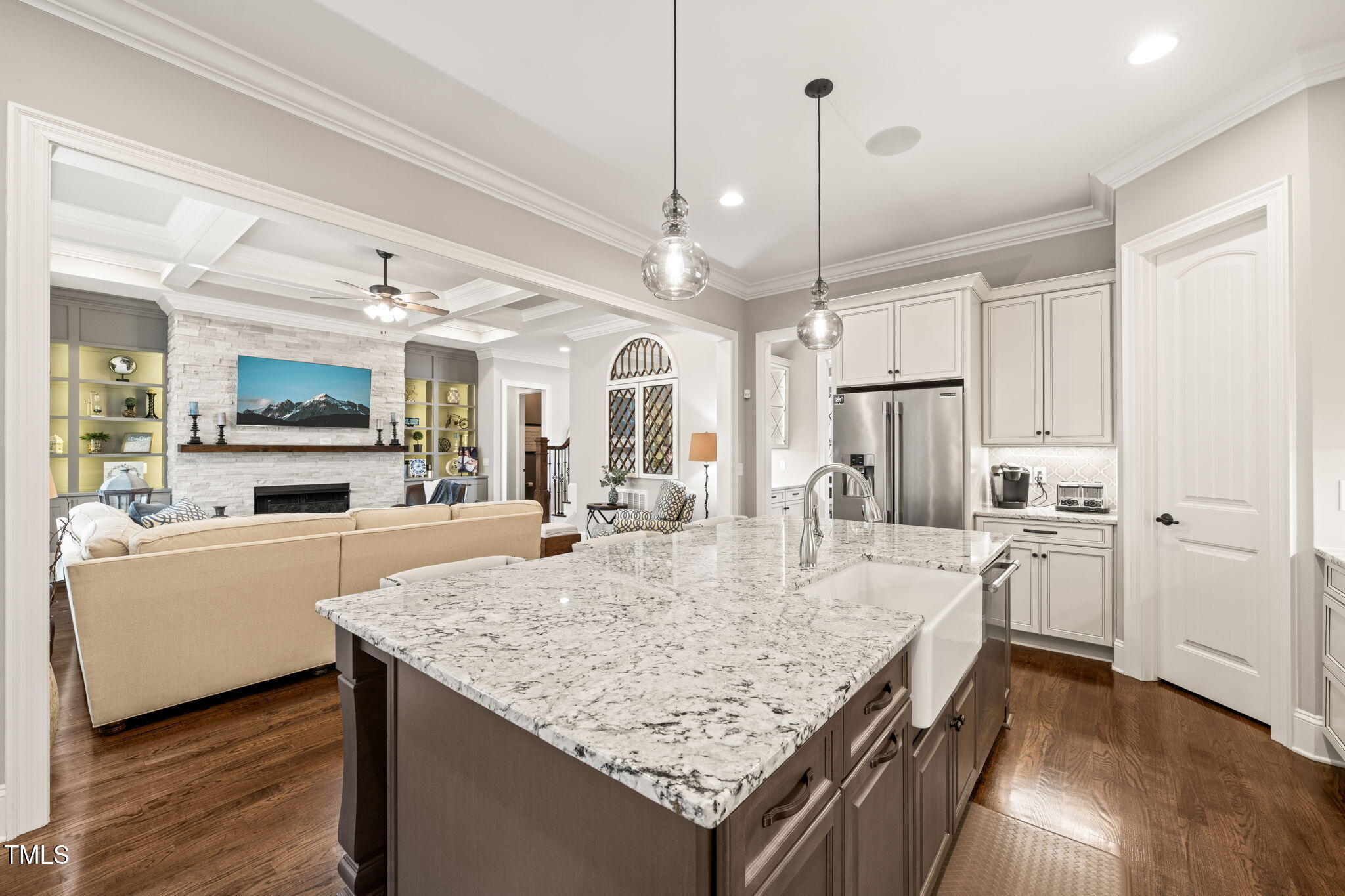 1301 Mackinaw Drive Wake Forest, NC 27587 - Photo 20 of 55 a kitchen with stainless steel appliances kitchen island granite countertop a table chairs and a refrigerator