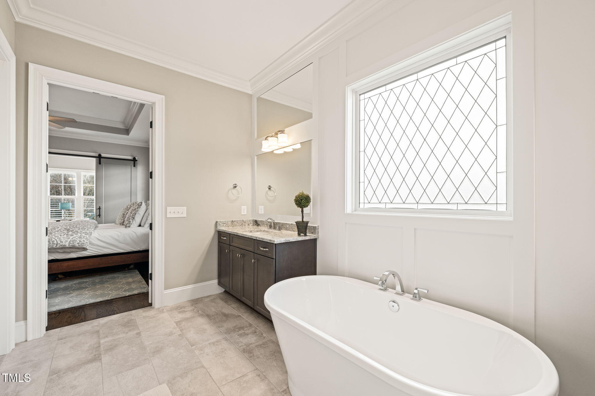 1301 Mackinaw Drive Wake Forest, NC 27587 - Photo 31 of 55 a bathroom with a tub sink and mirror