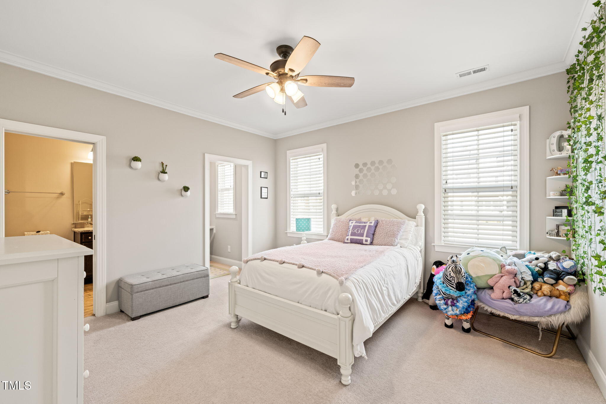 1301 Mackinaw Drive Wake Forest, NC 27587 - Photo 36 of 55 a bedroom with a bed and a chandelier