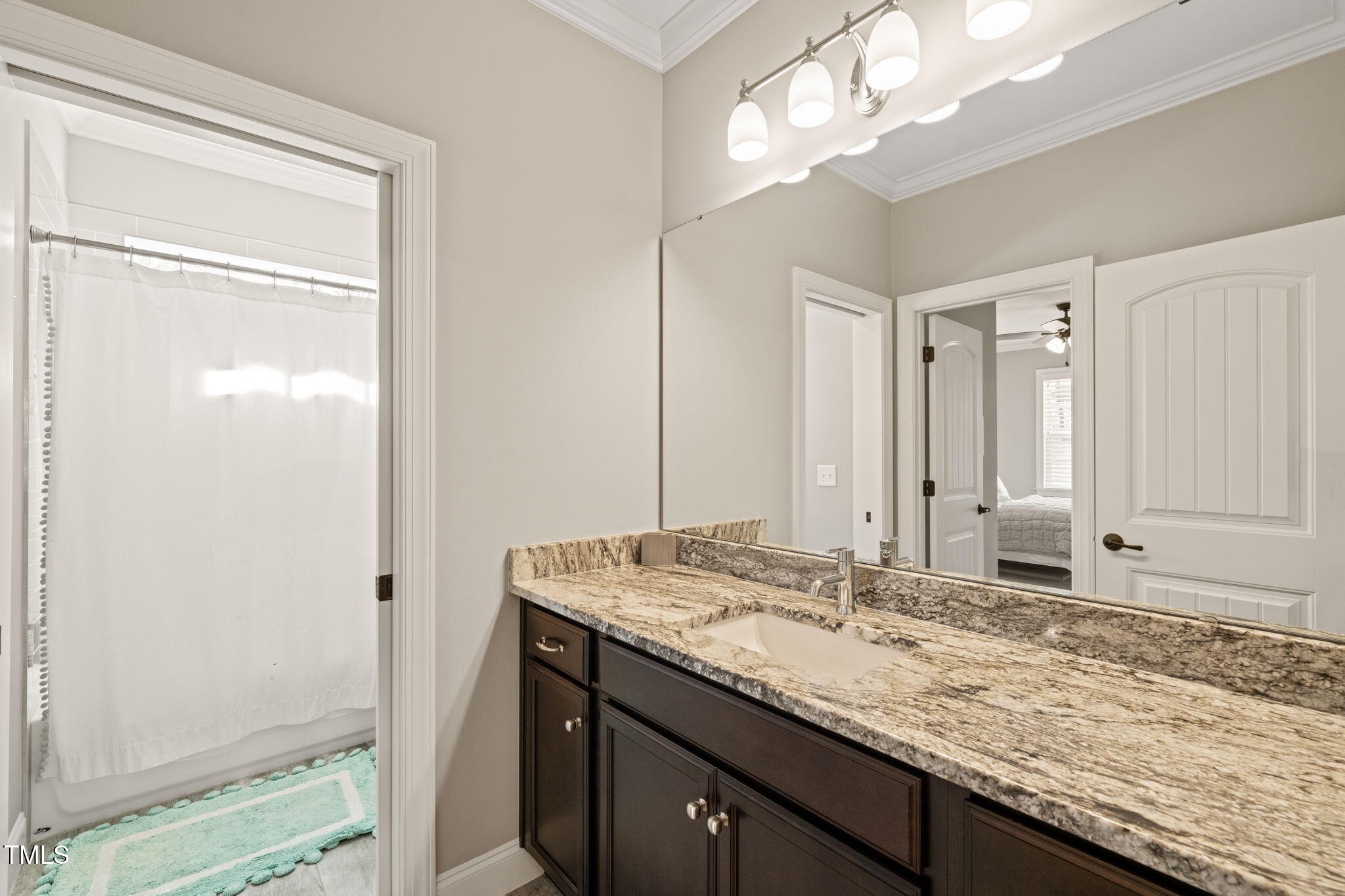 1301 Mackinaw Drive Wake Forest, NC 27587 - Photo 44 of 55 a bathroom with a granite countertop sink and a mirror