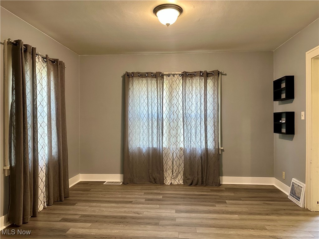 7954 Warren - Sharon Road Masury, OH 44438 - Photo 7 of 28 Unfurnished room featuring wood finished floors and baseboards