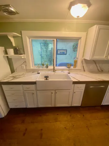 a kitchen that has a sink and a stove in it