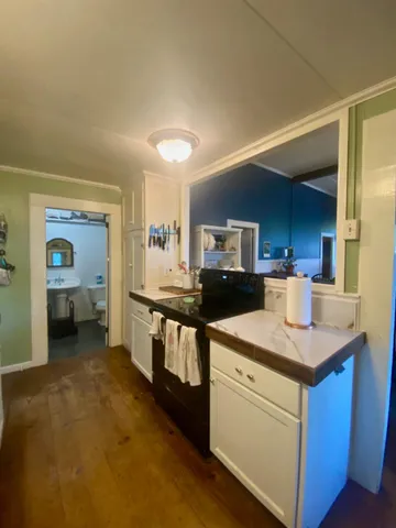 a dirt road with a building in the background