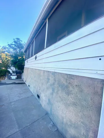 a view of a backyard with sitting area