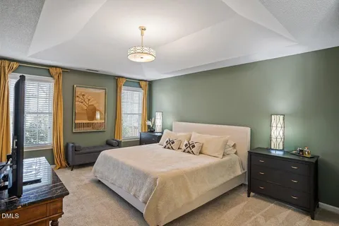 a bedroom with furniture and a flat screen tv