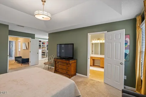 a view of an empty room with furniture and window