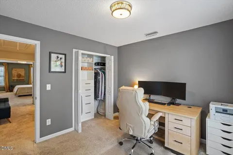 a view of walk in closet with clothes