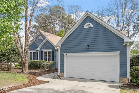 a view of a house with a patio and a yard