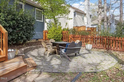 a roof deck with wooden floor and fence