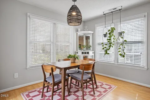 a dining room with furniture and a window