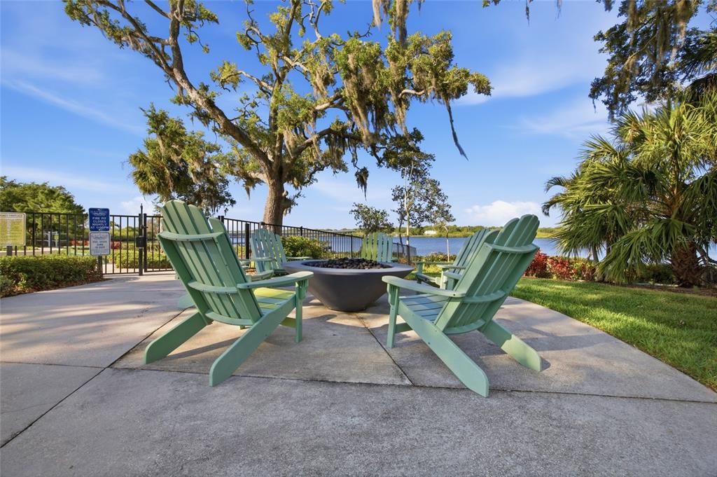2013 Sunset Wind Loop Oldsmar, FL 34677 - Photo 31 of 43 a view of a bench in a yard with potted plants