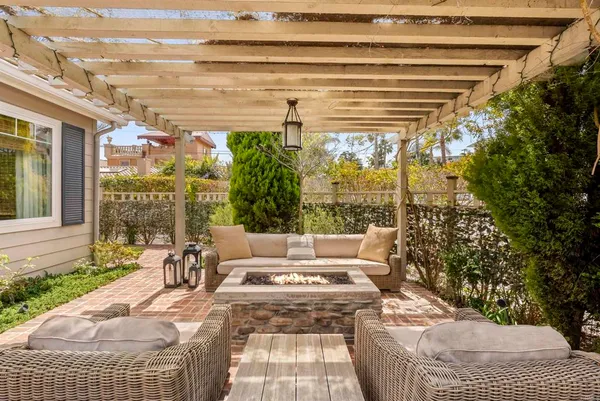 a view of a patio with a table and chairs and potted plants