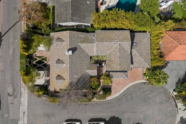 an aerial view of a house with a yard