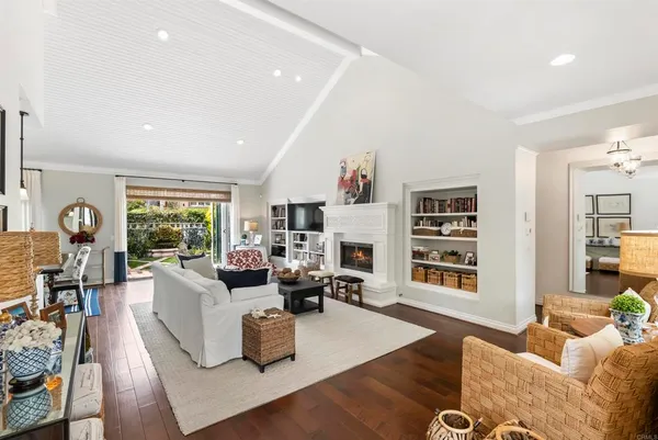 a living room with furniture fireplace and a window