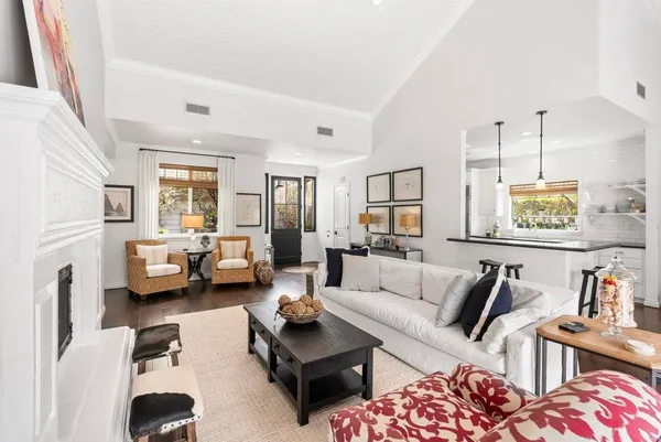a living room with furniture and a chandelier