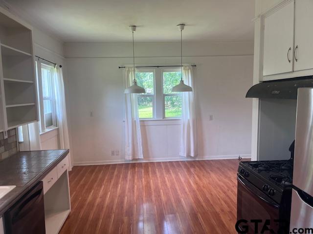 617 West Dobbs Street Tyler, TX 75701 - Photo 5 of 19 a kitchen with wooden floors and a granite counter tops