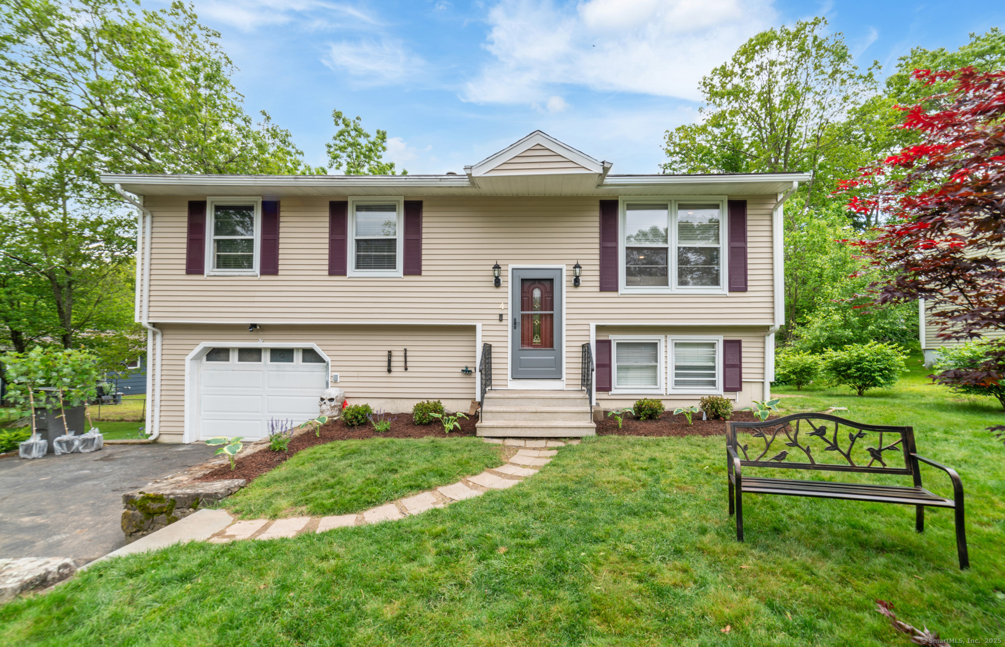 a front view of a house with a garden