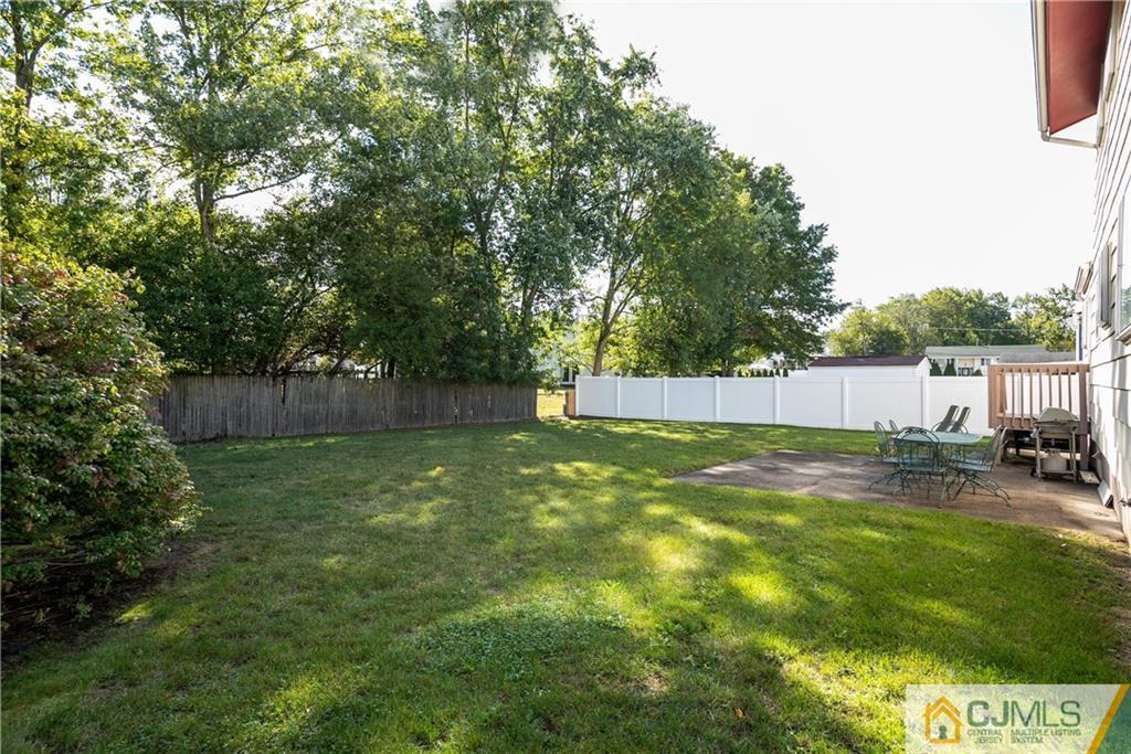 55 Gramercy Road Old Bridge, NJ 08857 - Photo 20 of 22 a view of a backyard with large trees