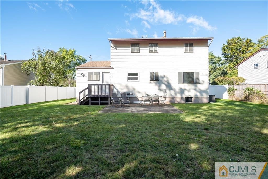 55 Gramercy Road Old Bridge, NJ 08857 - Photo 21 of 22 a backyard of a house with table and chairs